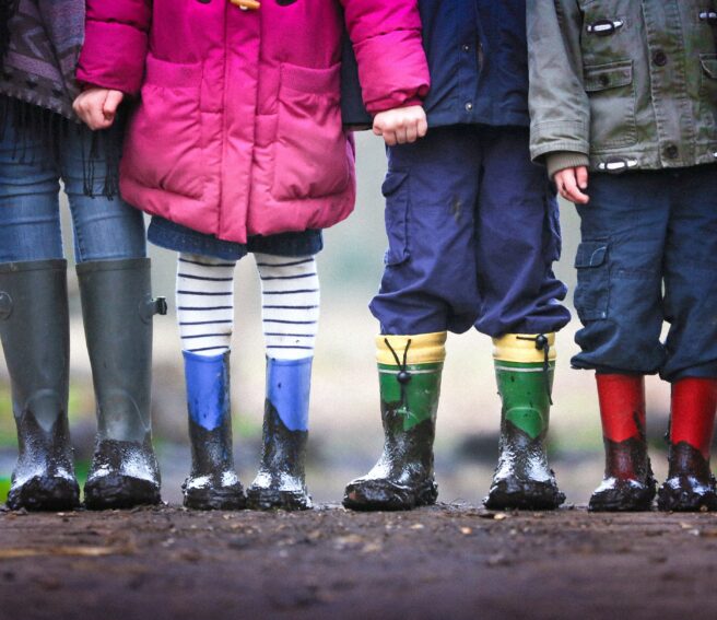 A pic of a bunch of schoolchidren's feet.